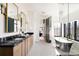 Elegant bathroom with a freestanding tub, double vanity, and stylish fixtures at 1641 S Corona St, Denver, CO 80210