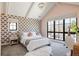Bright bedroom featuring a white ceiling with beam and fan wallpaper accent wall at 1641 S Corona St, Denver, CO 80210