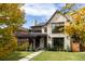 Stunning stone exterior with modern black trim, a covered porch and lush landscaping creates curb appeal at 1641 S Corona St, Denver, CO 80210