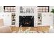 Elegant fireplace with marble surround, built-in shelving, and stylish decor, adds charm to the living space at 1641 S Corona St, Denver, CO 80210