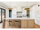 Spacious kitchen with a large center island, modern lighting, stainless steel appliances, and custom white cabinets at 1641 S Corona St, Denver, CO 80210