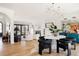 Open living space with dining area, modern decor, light wood floors, and custom shelving, perfect for entertaining at 1641 S Corona St, Denver, CO 80210