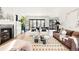 Bright living room with a fireplace, chic decor, and sliding doors leading to the backyard patio at 1641 S Corona St, Denver, CO 80210