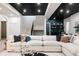 Spacious basement featuring a large white sectional, stairs, and wet bar at 1641 S Corona St, Denver, CO 80210
