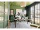 Trendy green home office featuring custom ceiling design, built-in shelves, and a large window at 1641 S Corona St, Denver, CO 80210