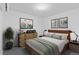 Well-lit bedroom featuring a dresser, bedside tables and modern art at 1601 Park Ave # 112, Denver, CO 80218
