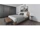 Comfortable bedroom with neutral tones, a large closet and bench at 1601 Park Ave # 112, Denver, CO 80218