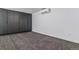 Contemporary bedroom features gray carpeting, built-in wardrobes, and modern air conditioning unit at 1601 Park Ave # 112, Denver, CO 80218