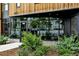 Contemporary building entrance with lush landscaping and large windows offers a welcoming atmosphere at 1601 Park Ave # 112, Denver, CO 80218