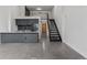 Spacious open floor plan features kitchen and stairs with metal railings that lead to loft at 1601 Park Ave # 112, Denver, CO 80218