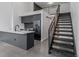 Open floor plan boasts a kitchen and stairs with metal railings that lead to the loft at 1601 Park Ave # 112, Denver, CO 80218