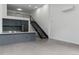 Open floor plan of living space features kitchen, staircase, and loft with high ceilings at 1601 Park Ave # 112, Denver, CO 80218