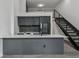 Modern kitchen with stainless steel appliances, black cabinets, and a stylish island at 1601 Park Ave # 112, Denver, CO 80218