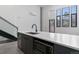 Open kitchen features a dark gray island with a black faucet and stainless steel microwave at 1601 Park Ave # 112, Denver, CO 80218