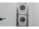 Stacked washer and dryer in a clean, white laundry closet at 1601 Park Ave # 112, Denver, CO 80218