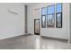 Bright living room featuring a modern door and large windows for natural light at 1601 Park Ave # 112, Denver, CO 80218