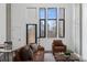 Living room featuring a plush leather sofa, chair, and many windows at 1601 Park Ave # 112, Denver, CO 80218