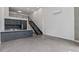 Bright living room featuring high ceilings, modern staircase, and open kitchen space at 1601 Park Ave # 112, Denver, CO 80218