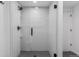 Walk-in shower with glass door and mosaic tile flooring at 1601 Park Ave # 112, Denver, CO 80218
