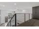 Upstairs hallway with carpet, black metal handrail, and views of the windows below at 1601 Park Ave # 112, Denver, CO 80218