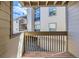 A covered balcony featuring a wood railing and views of the condo community at 701 Harlan St # E27, Lakewood, CO 80214