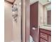 Cozy bathroom featuring a tiled shower and a wooden vanity at 701 Harlan St # E27, Lakewood, CO 80214