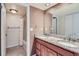 Bathroom with double vanity featuring granite countertops and neutral color palette at 701 Harlan St # E27, Lakewood, CO 80214