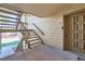 Apartment doorway with number 27, and wooden steps with railings leading to the upper level entrance at 701 Harlan St # E27, Lakewood, CO 80214