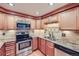 Well-equipped kitchen featuring stainless steel appliances and wood cabinets at 701 Harlan St # E27, Lakewood, CO 80214