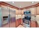 Modern kitchen featuring stainless steel appliances, granite countertops, and ample cabinet space at 701 Harlan St # E27, Lakewood, CO 80214