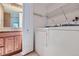 Laundry room featuring a full sized washer and dryer next to a bathroom at 701 Harlan St # E27, Lakewood, CO 80214