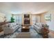 Inviting living room with fireplace, plush seating, and abundant natural light at 701 Harlan St # E27, Lakewood, CO 80214