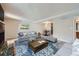 Bright living room with open access to dining room featuring hardwood floors and comfortable seating at 701 Harlan St # E27, Lakewood, CO 80214