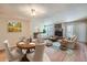 Spacious living room and dining area featuring a fireplace, hardwood floors, and lots of natural light at 701 Harlan St # E27, Lakewood, CO 80214
