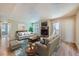 Comfortable living room with cozy fireplace, lots of seating, and sliding glass doors at 701 Harlan St # E27, Lakewood, CO 80214