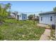 A view of the backyard with detached sheds, green grass, and other plants at 835 Knox Ct, Denver, CO 80204