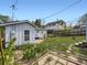 A backyard features detached sheds, lawn and plants, with a peek at the main house at 835 Knox Ct, Denver, CO 80204