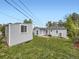 The well-manicured backyard includes detached sheds, green grass, and other plants at 835 Knox Ct, Denver, CO 80204