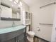 This bathroom features a modern sink, toilet, built-in storage cabinet, and a shower with curtain at 835 Knox Ct, Denver, CO 80204