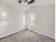 A bright bedroom with neutral carpet and vaulted ceiling offers ample natural light from multiple windows at 835 Knox Ct, Denver, CO 80204