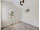 This bedroom features gray carpet, a window, ceiling fan, and air conditioning unit at 835 Knox Ct, Denver, CO 80204