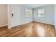 Cozy bedroom with hardwood floors, two windows, and fresh, neutral paint at 835 Knox Ct, Denver, CO 80204