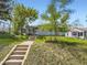 Inviting home exterior featuring a well-maintained lawn, charming front steps and mature trees at 835 Knox Ct, Denver, CO 80204