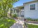 Close-up of a home's inviting front porch with decorative door, and landscaped surroundings at 835 Knox Ct, Denver, CO 80204