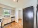 Well-equipped kitchen featuring modern appliances, neutral cabinets, and hardwood floors at 835 Knox Ct, Denver, CO 80204