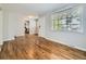 Open-plan living room featuring hardwood floors, connecting to the kitchen, with natural light at 835 Knox Ct, Denver, CO 80204