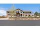 Inviting exterior of home with stone accents, manicured lawn, and beautiful landscaping, enhancing its curb appeal at 13007 Kuehster Rd, Littleton, CO 80127