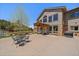 Exterior view of the home featuring outdoor dining area and stone detailing that enhances its inviting charm at 13007 Kuehster Rd, Littleton, CO 80127