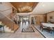 Grand foyer with soaring ceilings, wooden staircase, and views of the living area, creating an impressive entrance at 13007 Kuehster Rd, Littleton, CO 80127