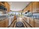 Bright eat-in kitchen features tile flooring, stainless steel appliances, and picturesque outdoor views at 13007 Kuehster Rd, Littleton, CO 80127